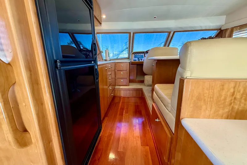 Slide: The Image of Interior of 2007 Navigator 44 Classic yacht with polished wood and beige seating. - 14