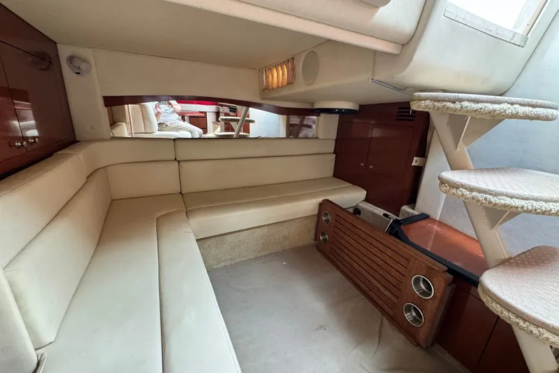 Slide: The Image of Interior of 2005 Sea Ray 340 Sundancer yacht with beige seating and wooden accents. - 21