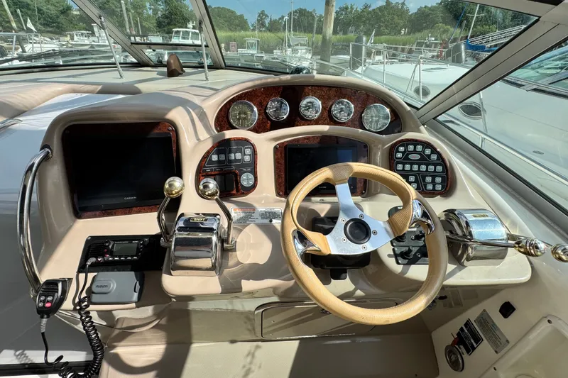 Slide: The Image of Helm of 2005 Sea Ray 340 Sundancer with steering wheel and control panel. - 8
