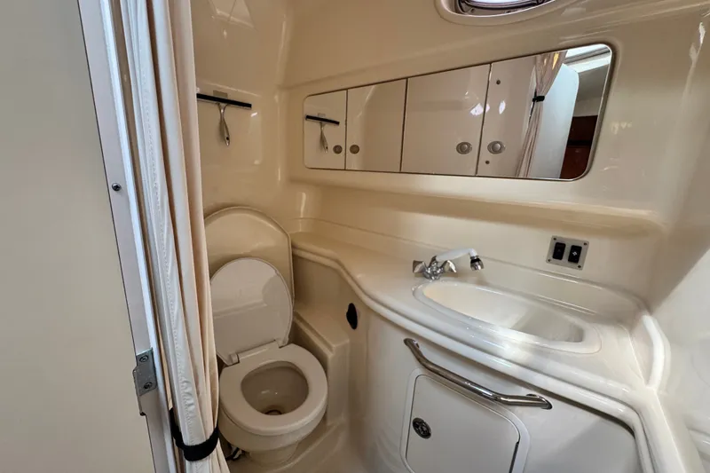 Slide: The Image of Bathroom interior of 2005 Sea Ray 340 Sundancer yacht, featuring sink and toilet. - 23