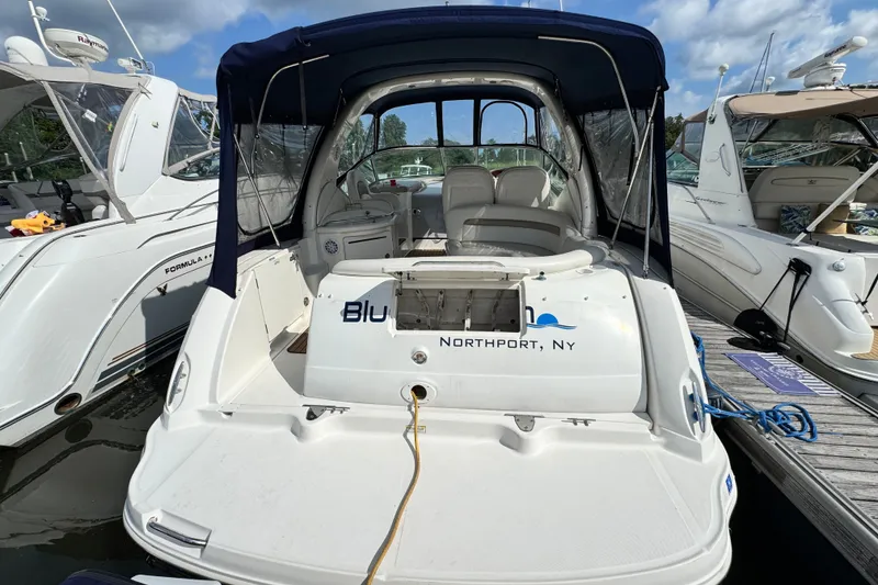 Slide: The Image of 2005 Sea Ray 340 Sundancer docked in Northport, NY, with blue canopy and sleek design. - 13