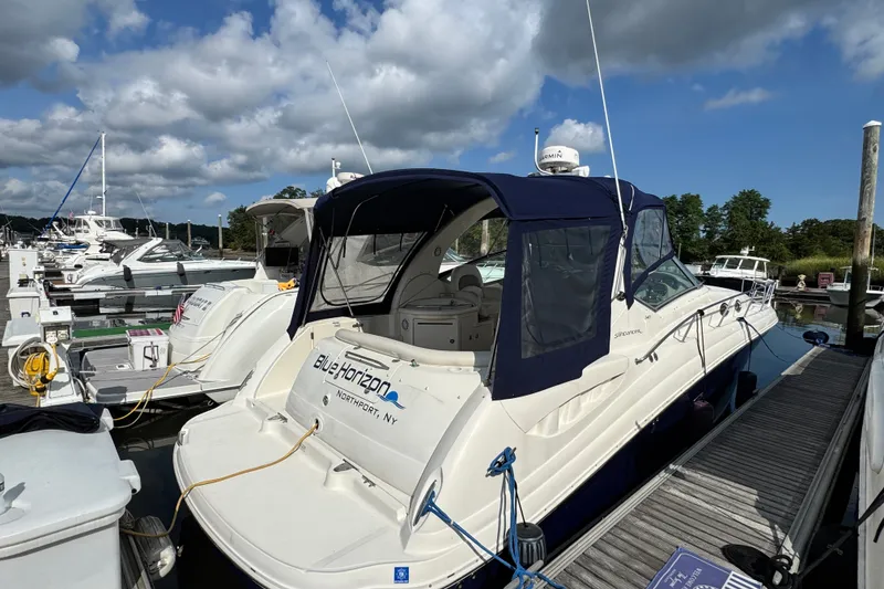 Slide: The Image of 2005 Sea Ray 340 Sundancer docked at marina under partly cloudy sky. - 1