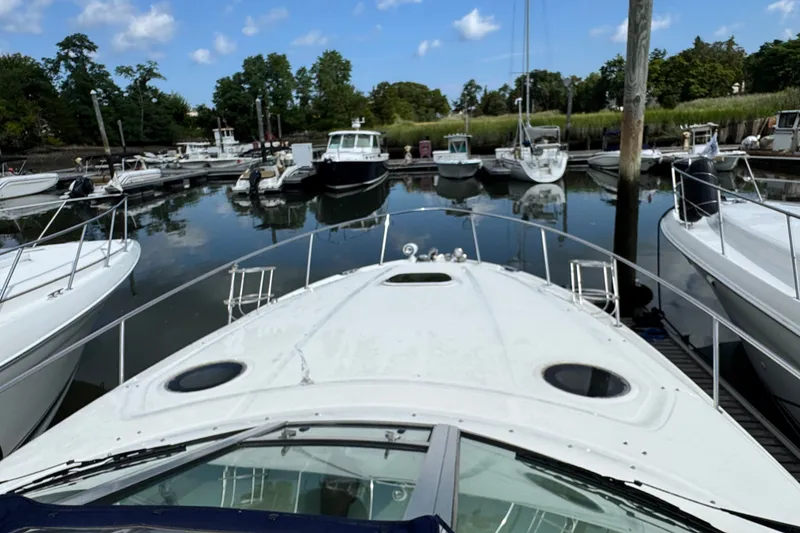 Slide: The Image of 2005 Sea Ray 340 Sundancer docked in a marina with other boats. - 29