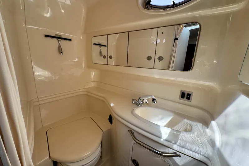 Slide: The Image of 2005 Sea Ray 340 Sundancer bathroom with sink, mirror, and toilet. - 24