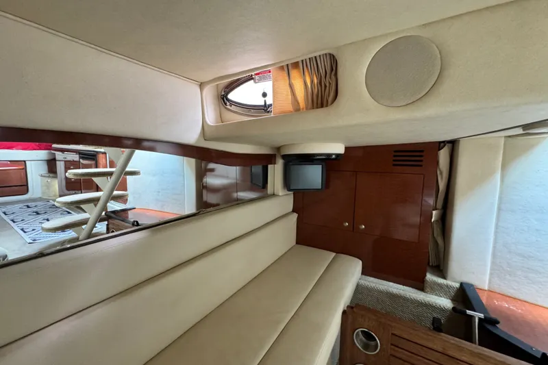 Slide: The Image of Interior of 2005 Sea Ray 340 Sundancer yacht with beige seating and wooden cabinetry. - 22