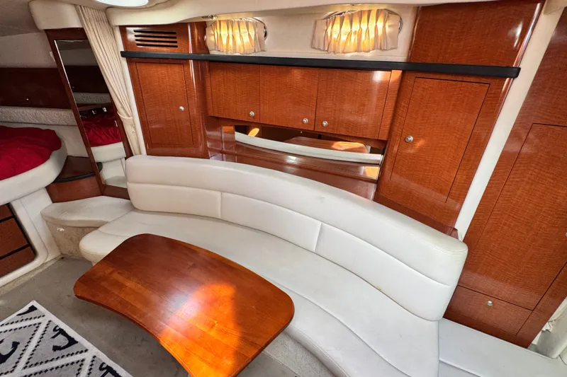 Slide: The Image of Luxurious interior of 2005 Sea Ray 340 Sundancer with elegant wood finishes and plush seating. - 16