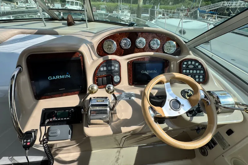 Slide: The Image of 2005 Sea Ray 340 Sundancer helm with Garmin displays and classic wood accents. - 7