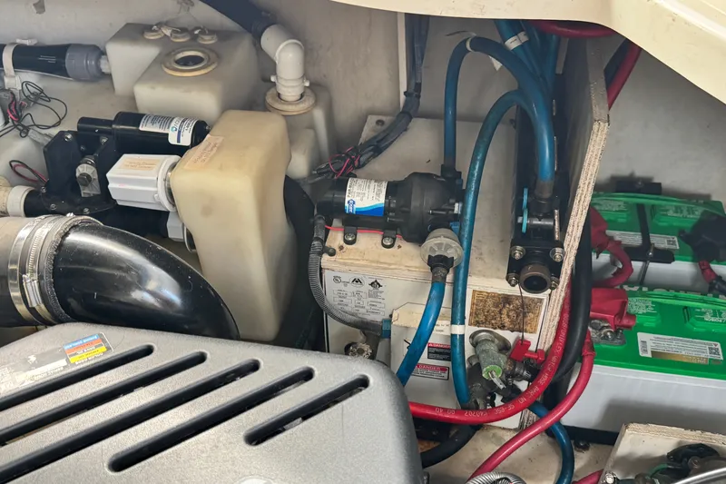 Slide: The Image of Engine compartment of a 2005 Sea Ray 340 Sundancer, showcasing mechanical components and wiring. - 28