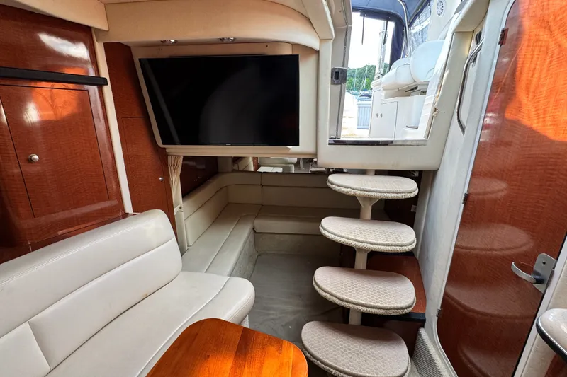 Slide: The Image of Interior of 2005 Sea Ray 340 Sundancer yacht with seating, TV, and stairs. - 20