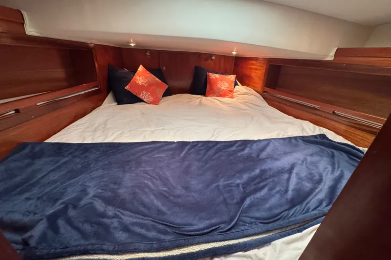 Slide: The Image of Cozy cabin bedroom in 2006 Navigator 34 Californian yacht with plush bedding and decorative pillows. - 31