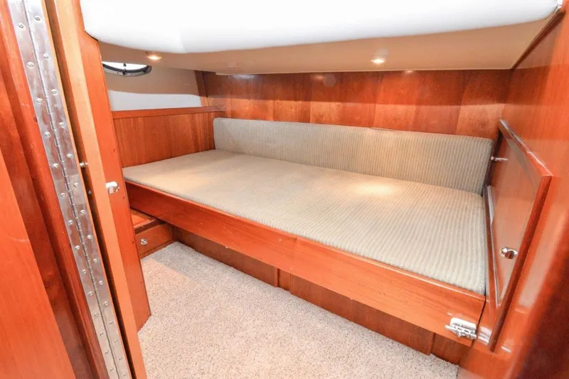 Slide: The Image of 2006 Navigator 34 Californian yacht cabin with wooden interior and cozy bed. - 27