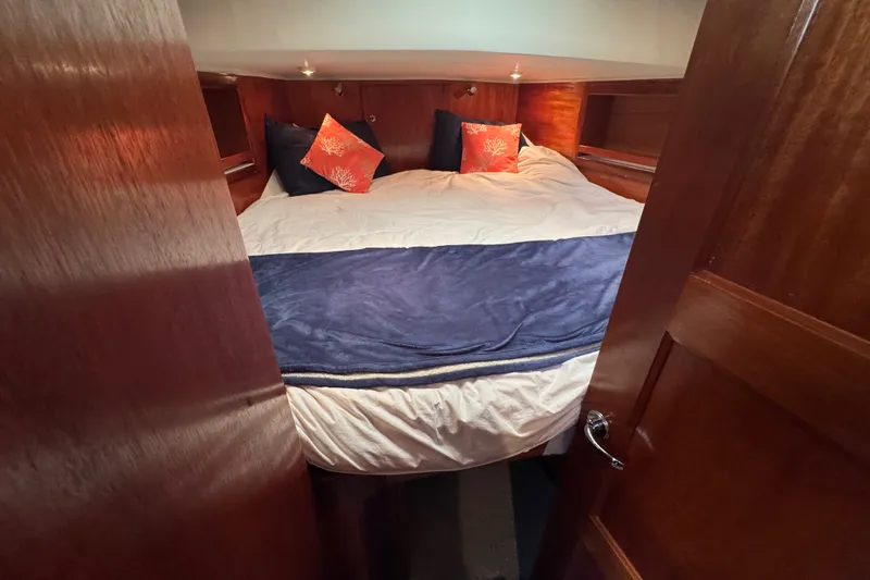 Slide: The Image of Cozy bedroom in 2006 Navigator 34 Californian yacht with wood paneling and decorative pillows. - 32