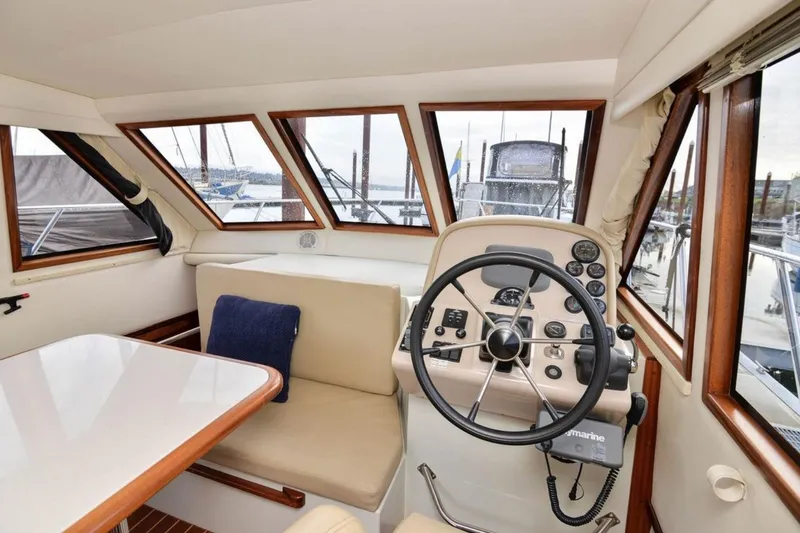 Slide: The Image of Interior of 2006 Navigator 34 Californian yacht with steering wheel and seating area. - 19