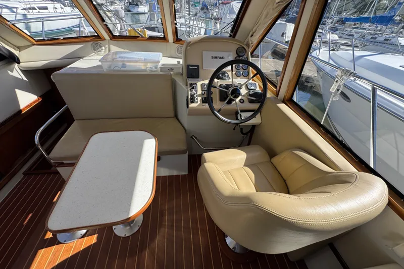 Slide: The Image of Interior of 2006 Navigator 34 Californian yacht with helm, seating, and table. - 18