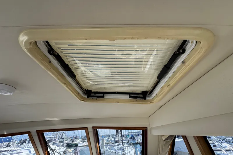 Slide: The Image of Ceiling hatch of 2006 Navigator 34 Californian yacht with marina view through windows. - 21
