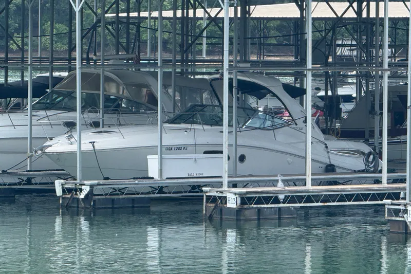 Slide: The Image of 2011 Sea Ray Sundancer 350 docked in a marina, surrounded by other boats. - 23