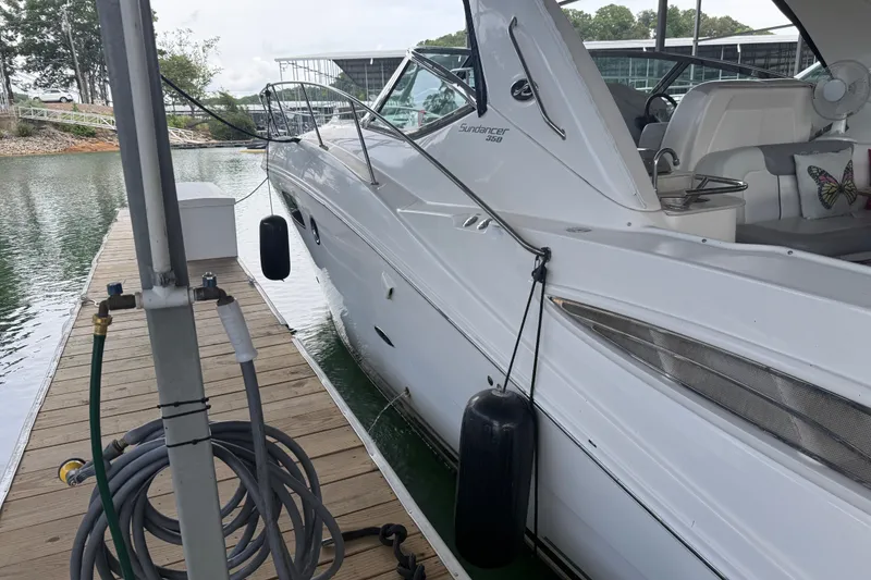 Slide: The Image of 2011 Sea Ray Sundancer 350 docked at marina, side view with water hose. - 3
