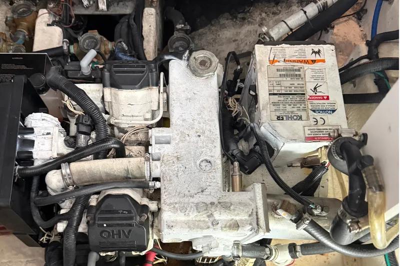 Slide: The Image of Engine compartment of a 2011 Sea Ray Sundancer 350, showcasing mechanical components and wiring. - 13
