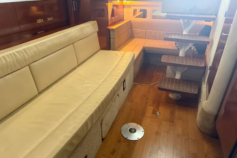 Slide: The Image of Interior of 2011 Sea Ray Sundancer 350 yacht with beige seating and wooden flooring. - 19