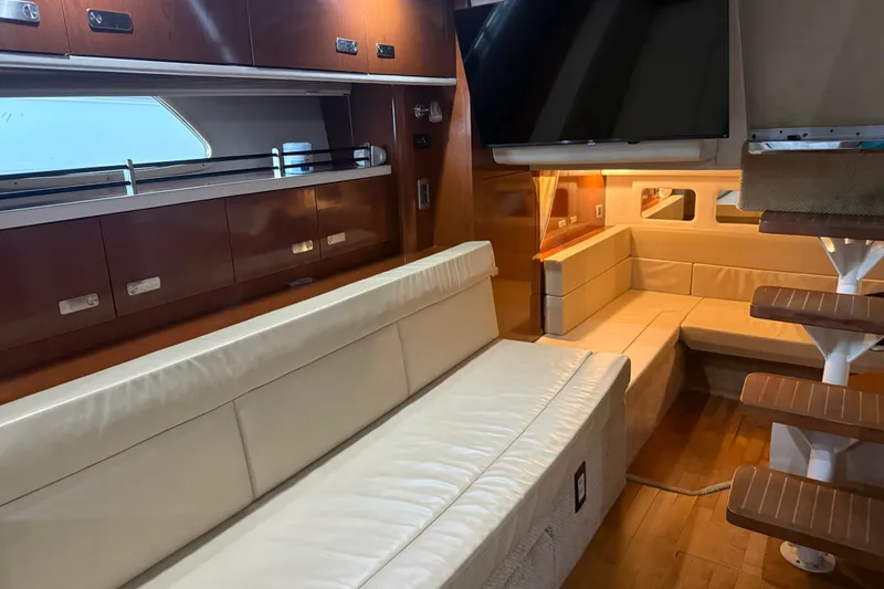 Slide: The Image of Luxurious interior of 2011 Sea Ray Sundancer 350 yacht with leather seating and wooden accents. - 18
