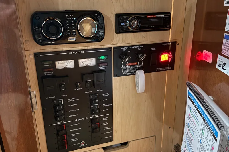 Slide: The Image of Control panel of a 2011 Sea Ray Sundancer 350 boat with audio system and generator controls. - 22