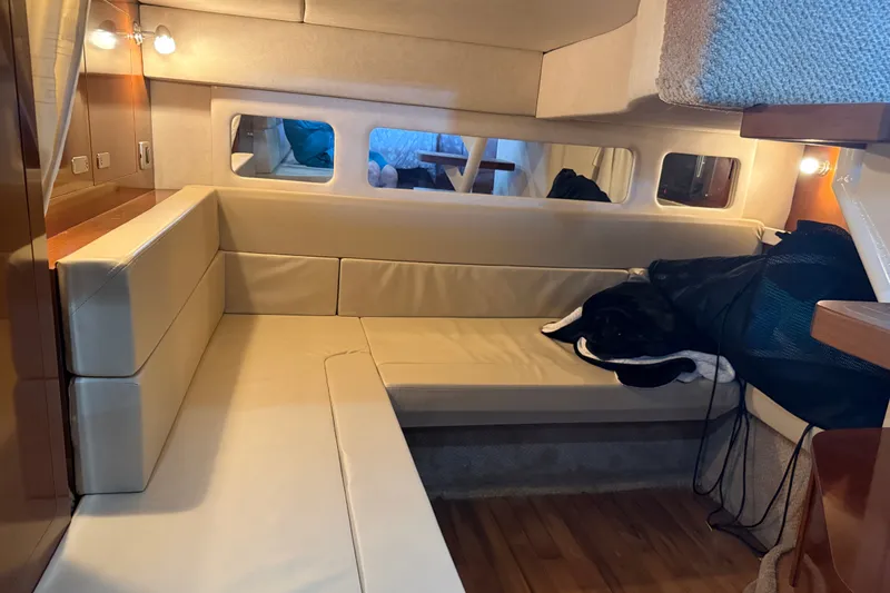 Slide: The Image of Interior of 2011 Sea Ray Sundancer 350 yacht with beige seating and wooden accents. - 21