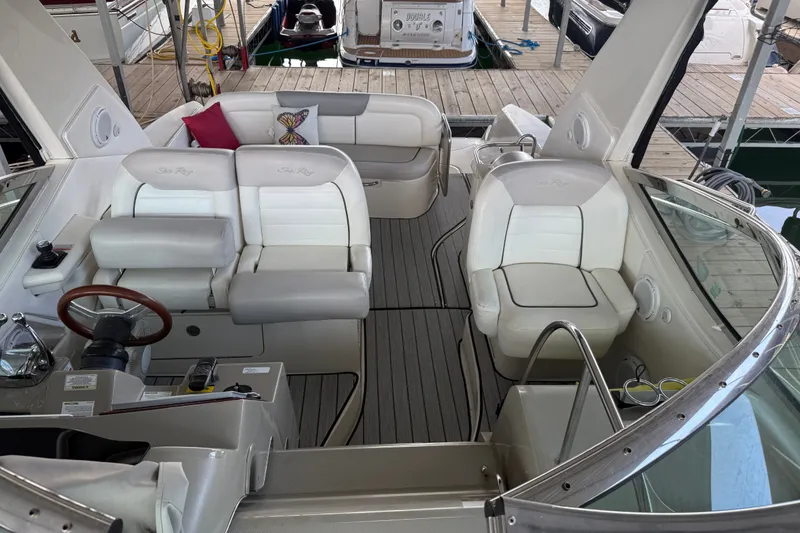 Slide: The Image of 2011 Sea Ray Sundancer 350 interior with white seating and wooden steering wheel. - 13