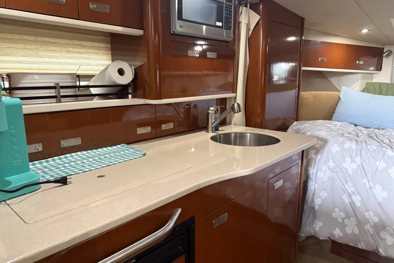 Slide: The Image of Luxurious interior of 2011 Sea Ray Sundancer 350 yacht with kitchenette and cozy sleeping area. - 16