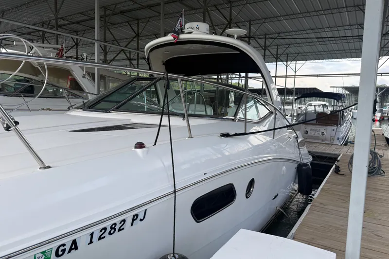 Slide: The Image of 2011 Sea Ray Sundancer 350 docked in a covered marina, side view. - 2