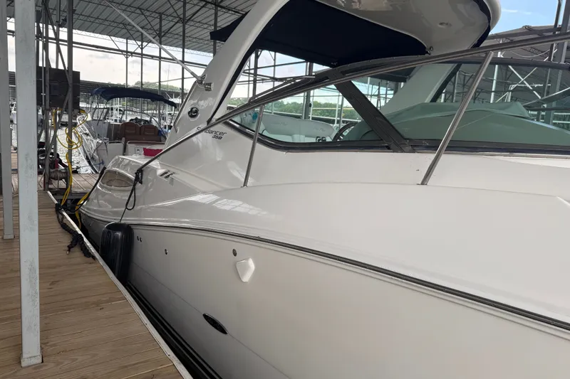 Slide: The Image of 2011 Sea Ray Sundancer 350 docked in a marina under a covered structure. - 4