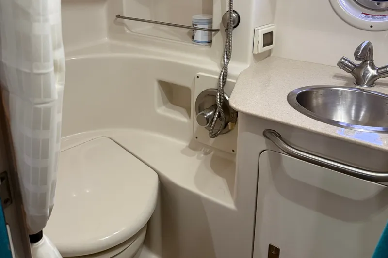 Slide: The Image of Bathroom interior of 2011 Sea Ray Sundancer 350 yacht, featuring toilet and sink. - 20