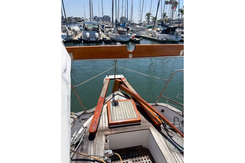 Slide: The Image of 1973 Westsail 32 sailboat docked in a marina, surrounded by other boats. - 5