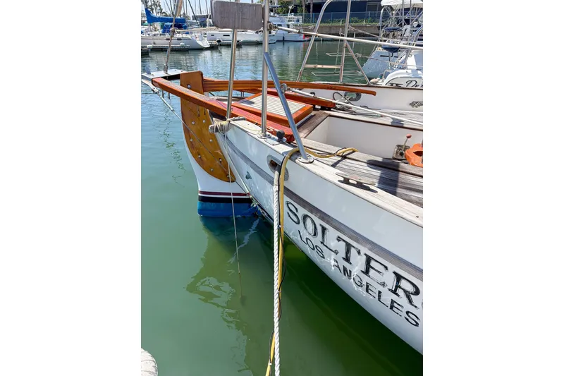 Slide: The Image of 1973 Westsail 32 sailboat docked in marina, featuring wooden accents and Los Angeles registration. - 6