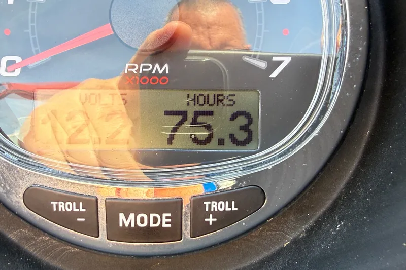 Slide: The Image of Close-up of a Bennington R 24 Quad Bench Bowrider gauge showing 75.3 hours and 12.2 volts. - 23