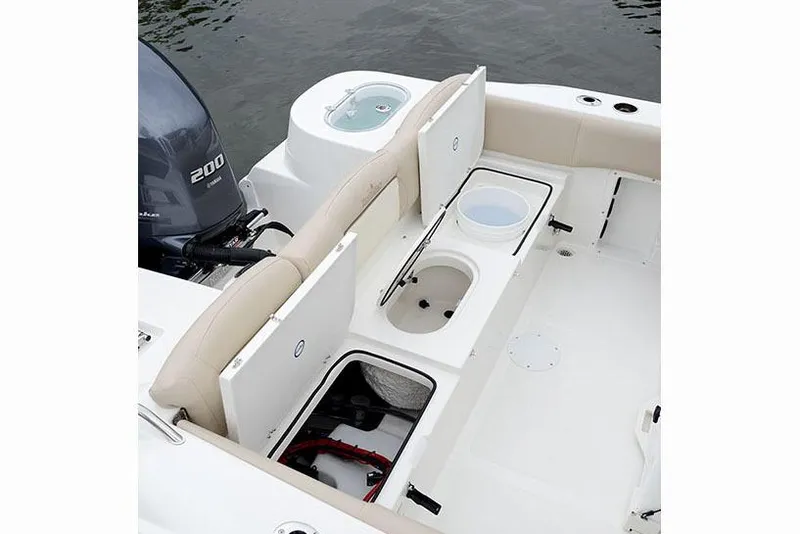 Slide: The Image of Manufacturer Provided Image: 2018 NauticStar 2302 Legacy boat interior with storage compartments and Yamaha 200 engine. - 5