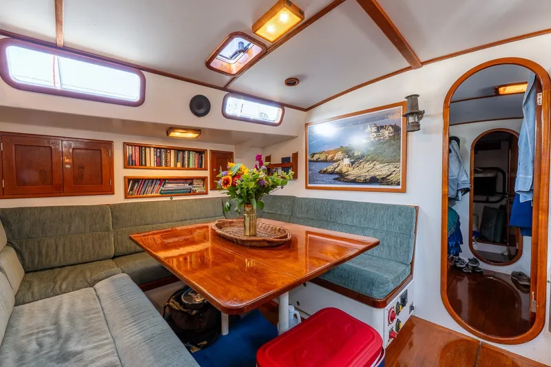 Slide: The Image of Cozy interior of 1993 Van De Stadt Samoa 47 yacht with wooden table and seating. - 24