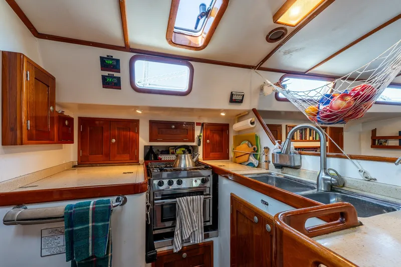 Slide: The Image of Cozy kitchen in 1993 Van De Stadt Samoa 47 yacht with wooden cabinets and modern amenities. - 23