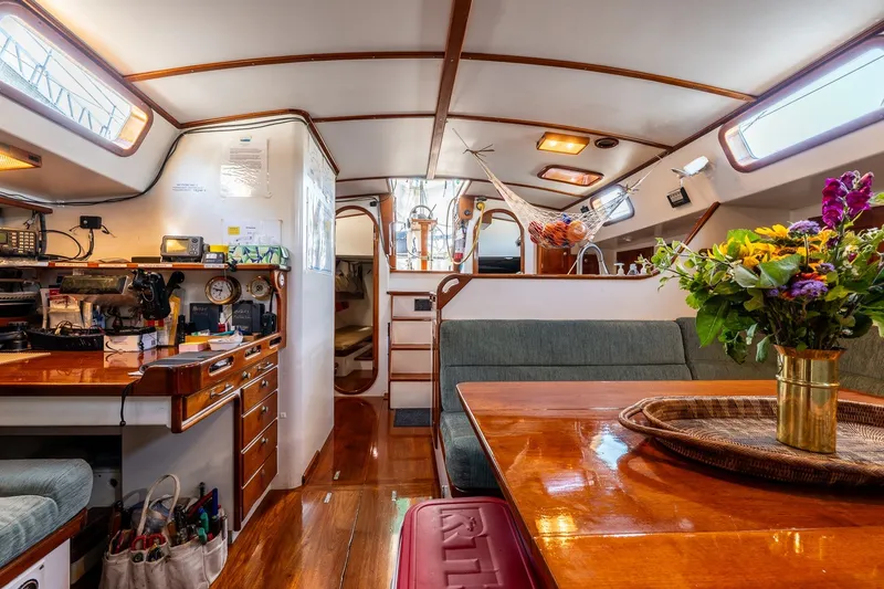 Slide: The Image of Interior of 1993 Van De Stadt Samoa 47 yacht with elegant wood finish and floral arrangement. - 28