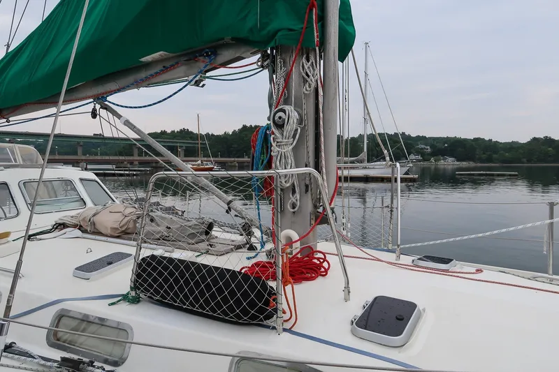 Slide: The Image of Van De Stadt Samoa 47 sailboat deck with rigging, docked in a calm marina, 1993 model. - 10