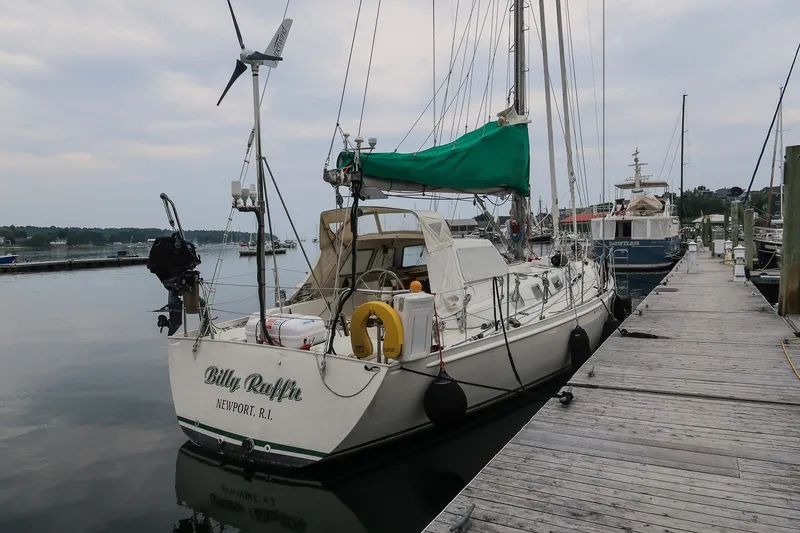 Slide: The Image of Sailing yacht Van De Stadt Samoa 47, 1993, docked at a marina with green sail cover. - 1