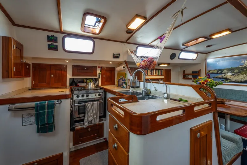 Slide: The Image of Interior of 1993 Van De Stadt Samoa 47 yacht with kitchen and dining area. - 16