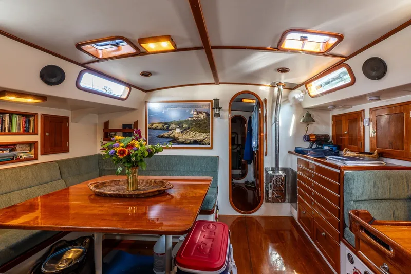 Slide: The Image of Cozy interior of 1993 Van De Stadt Samoa 47 yacht with wooden furnishings and floral centerpiece. - 25
