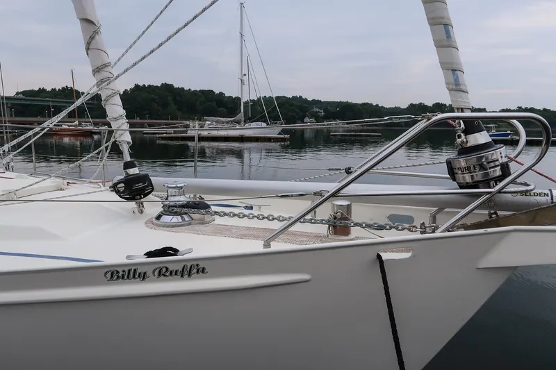 Slide: The Image of Van De Stadt Samoa 47 sailboat docked, 1993 model, with calm water and scenic background. - 11