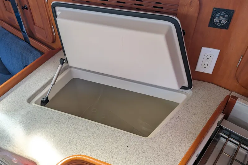 Slide: The Image of Open storage compartment in a 2005 C&C 115 sailboat interior. - 42