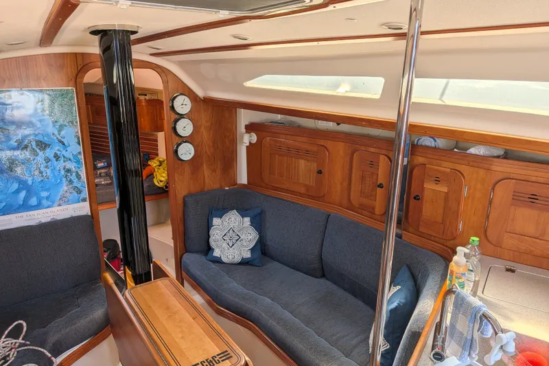 Slide: The Image of Interior of a 2005 C&C 115 sailboat with cozy seating and wooden cabinetry. - 32