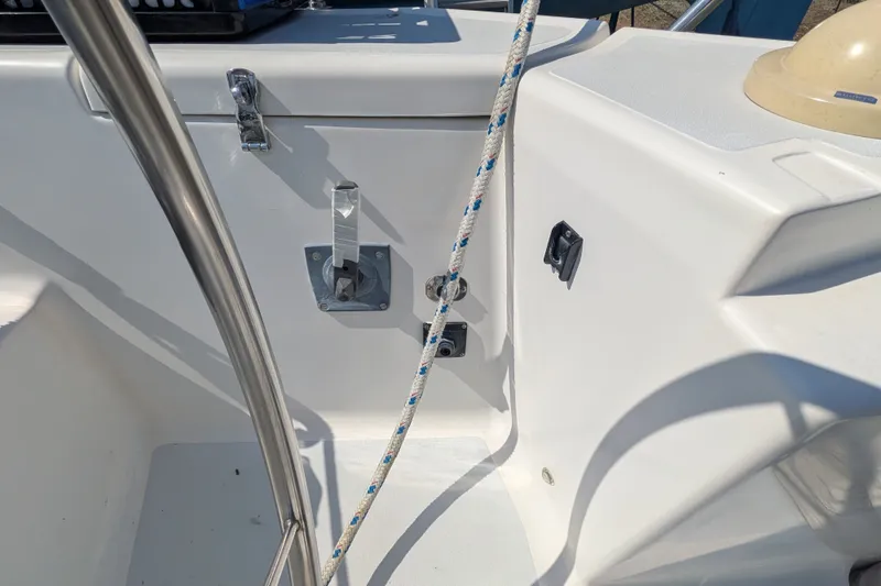 Slide: The Image of Cockpit area of a 2005 C&C 115 sailboat, featuring steering wheel and rigging details. - 13