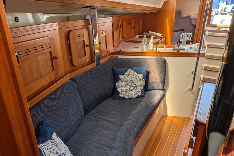 Slide: The Image of Interior of 2005 C&C 115 sailboat with cozy seating and wooden cabinetry. - 43
