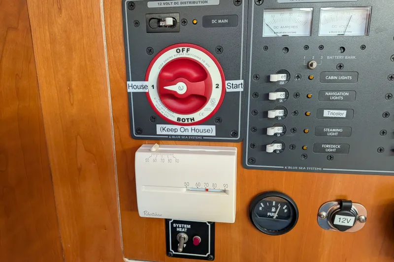 Slide: The Image of Electrical control panel on a 2005 C&C 115 boat with switches and gauges. - 35
