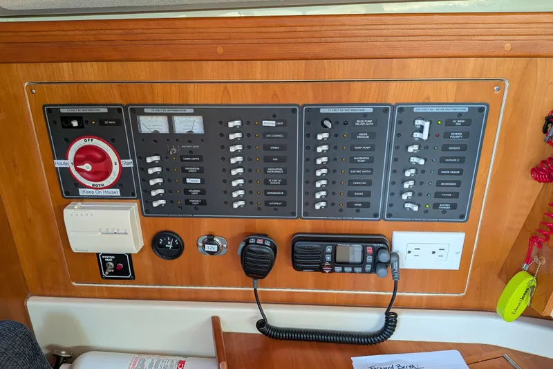 Slide: The Image of Control panel of a 2005 C&C 115 yacht with switches and communication devices. - 36
