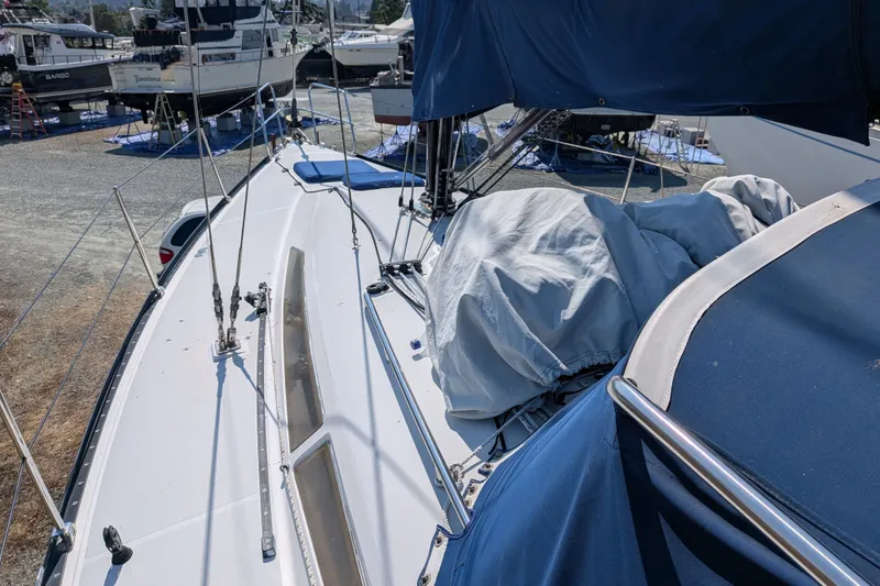 Slide: The Image of Sailboat deck view, C&C 115 model, 2005, in a marina with covered equipment. - 23